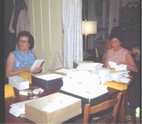 Stuffing the envelopes at the dining table.